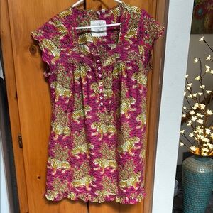 Pink smocked blouse with scoop neck and cap sleeves